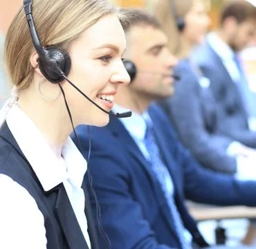 Female customer support operator with headset and smiling. Stock Photos