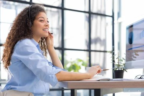 Female customer support operator with headset and smiling. Stock Photos