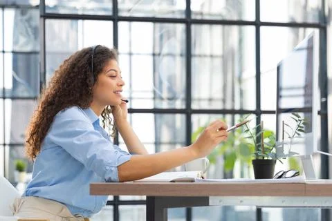 Female customer support operator with headset and smiling. Stock Photos