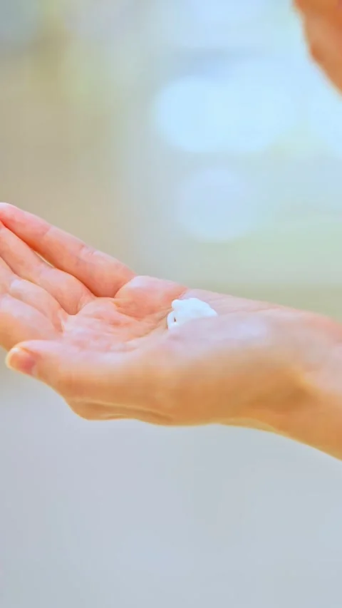 Female customer testing cream on hand while choosing skincare product in store Stock Footage 315667888