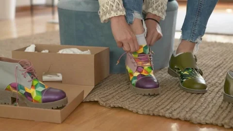 Female customer trying on shoes while shopping for footwear in shoe store. Stock Footage 265945479