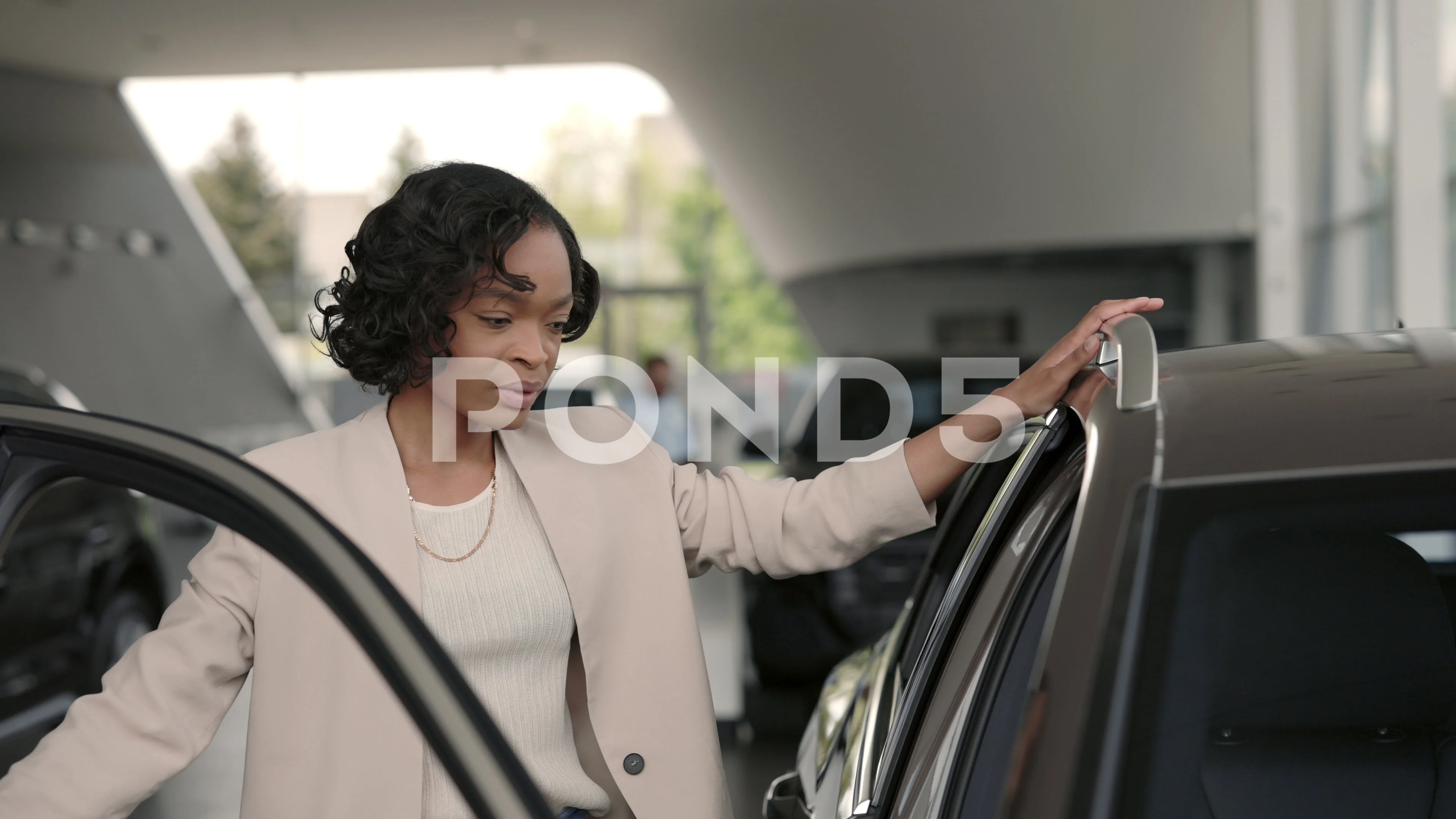 Female customer visiting auto salon for buying new vehicle pic