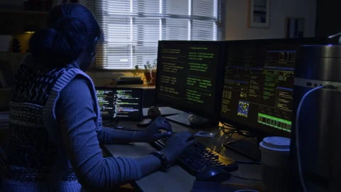 Female Cybercriminal Coding on Computer with Multiple Screens at Night Stock Footage 328251909