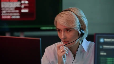 Female Cybersecurity Operator in Headset Reporting System Breach in Control Room 스톡 동영상 334935536