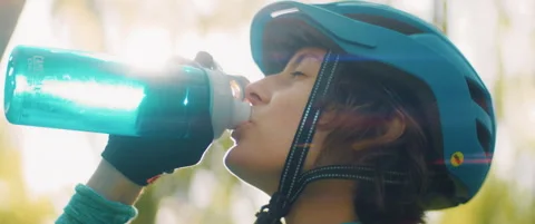Female Cyclists Drinks from Bottle in Forest Stock Footage 157607958