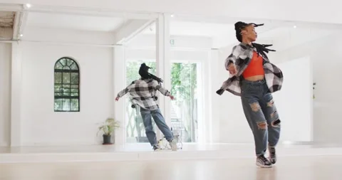 Female dancer dancing alone in front of mirror in dance studio, slow motion Stock Footage 339412781