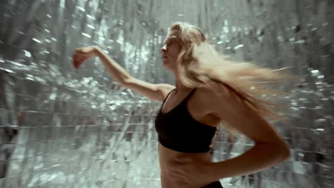Female Dancer Performing Dynamic Contemporary Movements in Silver Room Stock Footage 306990892