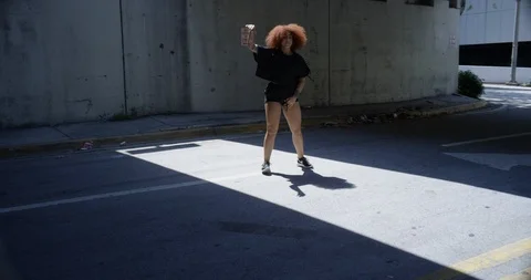 Female dancer performing her routine under an overpass Stock Footage 97026128