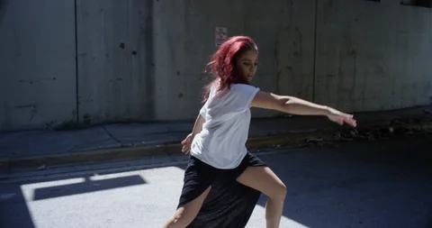 Female dancer performing her routine under an overpass Stock Footage 97032629