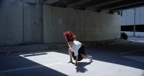Female dancer performing her routine under an overpass Stock Footage 97033631
