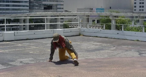 Female dancer performing her routine on top of a parking garage Stock Footage 97033940