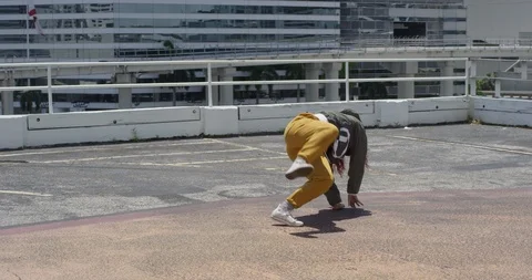 Female dancer performing her routine on top of a parking garage Stock Footage 97034435