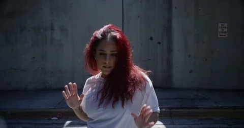 Female dancer performing her routine under an overpass Stock Footage 97034672