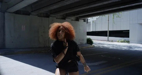 Female dancer performing her routine under an overpass Stock Footage 97035805