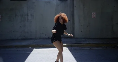 Female dancer performing her routine under an overpass Stock Footage 97036524