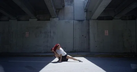 Female dancer performing her routine under an overpass Stock Footage 97037224