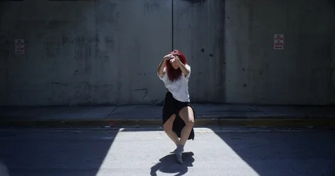 Female dancer performing her routine under an overpass Stock Footage 97037679
