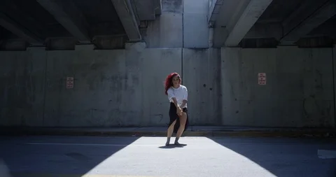 Female dancer performing her routine under an overpass Stock Footage 97037815