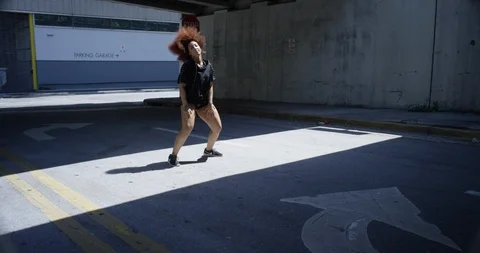 Female dancer performing her routine under an overpass Stock Footage 97038864