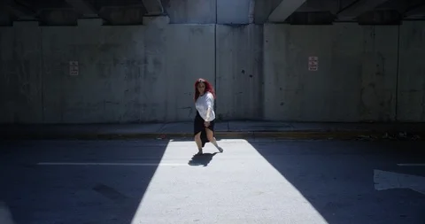 Female dancer performing her routine under an overpass Stock Footage 97041561