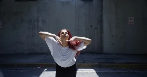 Female dancer performing her routine under an overpass Stock Footage 97042628