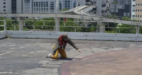 Female dancer performing her routine on top of a parking garage Stock Footage 97240052