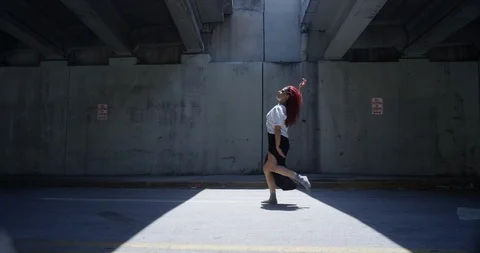 Female dancer performing her routine under an overpass Stock Footage 97241509