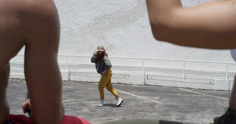 Female dancer performing her routine on top of a parking garage Stock Footage 97241858