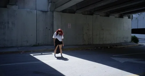 Female dancer performing her routine under an overpass Stock Footage 97242370