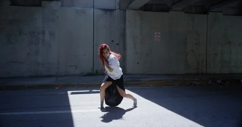Female dancer performing her routine under an overpass Stock Footage 97242899