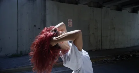 Female dancer performing her routine under an overpass Stock Footage 97244964