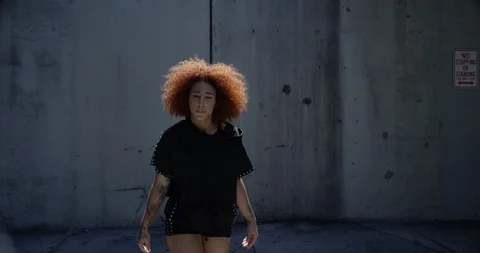 Female dancer performing her routine under an overpass Stock Footage 97389201