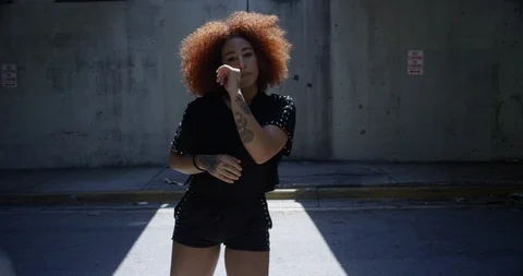Female dancer performing her routine under an overpass Stock Footage 97389435