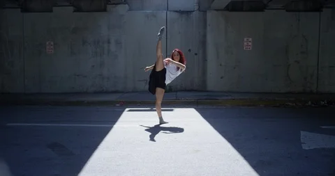 Female dancer performing her routine under an overpass Stock Footage 97389799