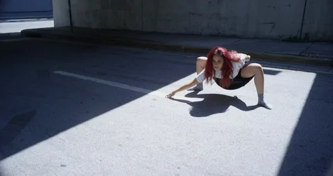 Female dancer performing her routine under an overpass Stock Footage 97389974