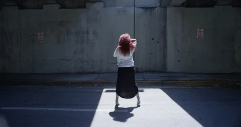 Female dancer performing her routine under an overpass Stock Footage 97390254