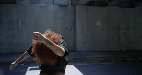 Female dancer performing her routine under an overpass Stock Footage 97446279