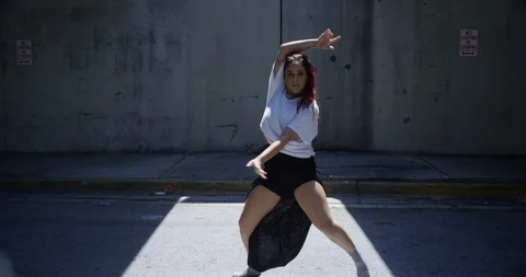 Female dancer performing her routine under an overpass Stock Footage 97446907