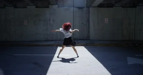 Female dancer performing her routine under an overpass Stock Footage 97447448