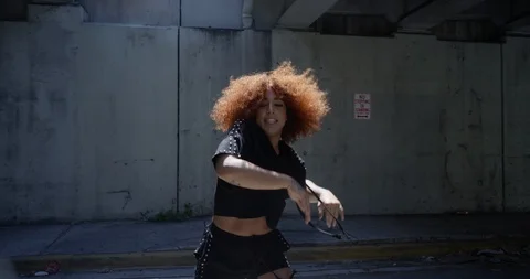 Female dancer performing her routine under an overpass Stock Footage 97450144