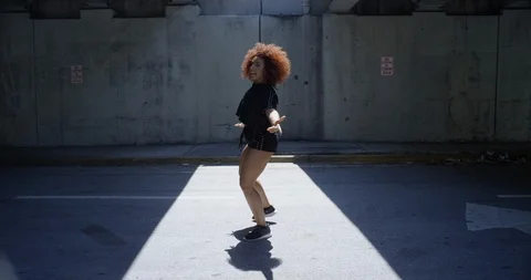 Female dancer performing her routine under an overpass Stock Footage 97450323