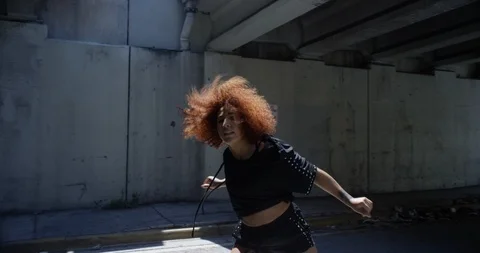 Female dancer performing her routine under an overpass Stock Footage 97451276