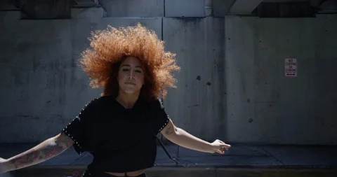 Female dancer performing her routine under an overpass Stock Footage 97452944