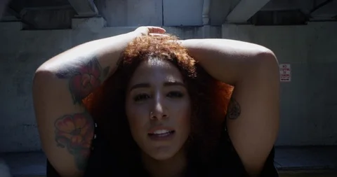 Female dancer performing her routine under an overpass Stock Footage 97453828