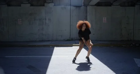 Female dancer performing her routine under an overpass Stock Footage 97455512