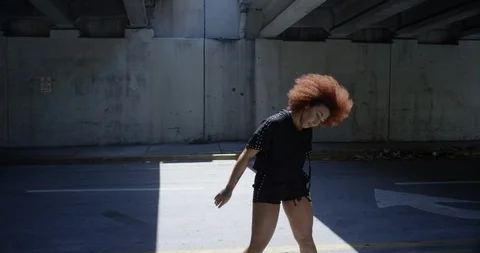 Female dancer performing her routine under an overpass Stock Footage 97501670