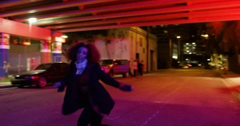 Female dancer performing her routine under an overpass at night Stock Footage 100182196