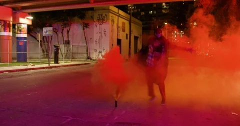Female dancer performing her routine under an overpass at night with smoke bombs Stock Footage 100182518