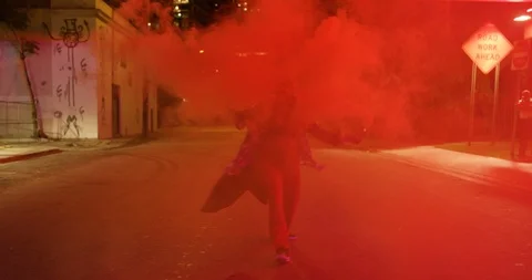 Female dancer performing her routine under an overpass at night with smoke bombs Stock Footage 100182581