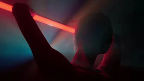 Female dancer performs modern choreography elements with red neon lightbar Stock Footage 242911980